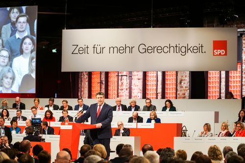 Sigmar Gabriel kommt als scheidendem Parteivorsitzenden die Gratwanderung zwischen Abschied und Aufbruch zu. Sein Ziel: Auf Melancholie verzichten und auf die Wahl von Martin Schulz einschwören. „Es dürfte der fröhlichste und optimistischste Übergang zu einem neuen Parteivorsitzenden sein, den unsere Partei in den letzten Jahrzehnten erlebt hat“, sagt Gabriel und untermauert mit seiner Rede die klar auf Schulz zugeschnittene Inszenierung. Sinnbildlich dafür ist auch der in der Halle immer wieder präsentierte Schriftzug „Zeit für Gerechtigkeit“, der bereits vor dem Parteitag als Wahlkampfmotto ausgegeben wurde.