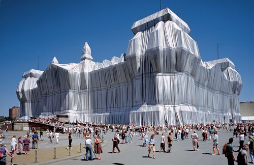 „Es ist total irrational und sinnlos“, sagte der bulgarisch-amerikanische Verpackungskünstler Christo einmal über seine Arbeiten. Trotzdem faszinierten seine gigantischen Installationen Millionen Menschen – unvergessen: der 1995 verhüllte Berliner Reichstag. In silberne Stoffbahnen gewickelt und mit blauen Seilen verschnürt wurde das Haus der Demokratie für zwei Wochen zur künstlerischen Pilgerstätte. Für das Projekt hatte das Künstlerpaar jahrzehntelang um eine Genehmigung gekämpft. Die Verhüllung habe dem Reichstag „zu neuer Sichtbarkeit“ verholfen und auch „zu der Bedeutung, die der Sitz des Parlaments für uns Heutige hat“, sagte Kulturstaatsministerin Monika Grütters in einer Mitteilung unmittelbar nach dem Tod des Künstlers. „Die Tage des verhüllten Reichstages sind mit ihrem Charakter eines friedlichen Volksfestes Teil unseres kollektiven gesellschaftlichen Gedächtnisses geworden“, so Grütters. Sie würdigte Christo als „einen der ganz großen Künstler unserer Zeit“.